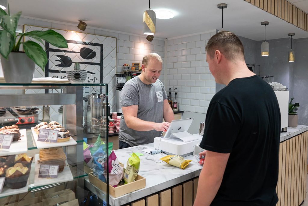 Customer being served at the Sugar Snap Kitchen café counter at Hope Park